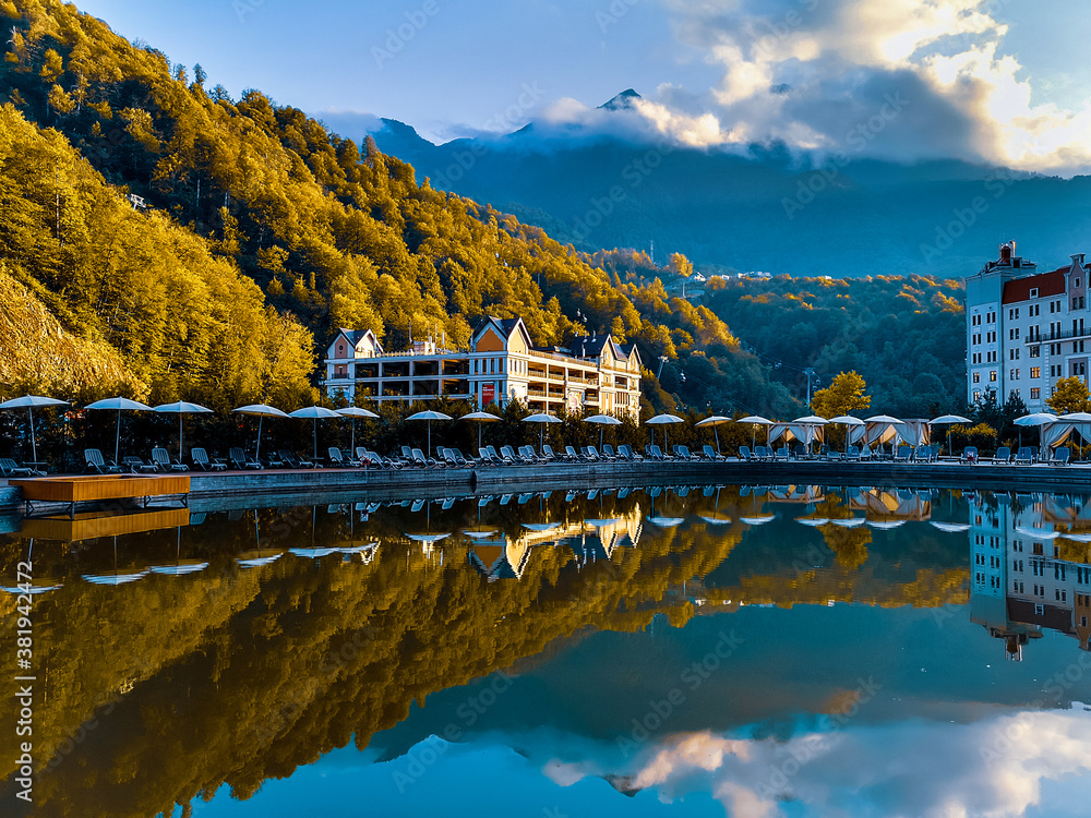 Reflection of the Krasnaya Polyana mountains (Sochi, Russia) in a pond in autumn