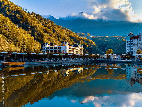Reflection of the Krasnaya Polyana mountains (Sochi, Russia) in a pond in autumn photo