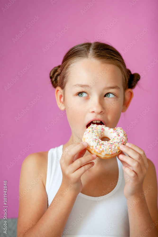 cute girl holding an appetizing glazed donut in her hands cute girl holding an appetizing glazed donut in her hands