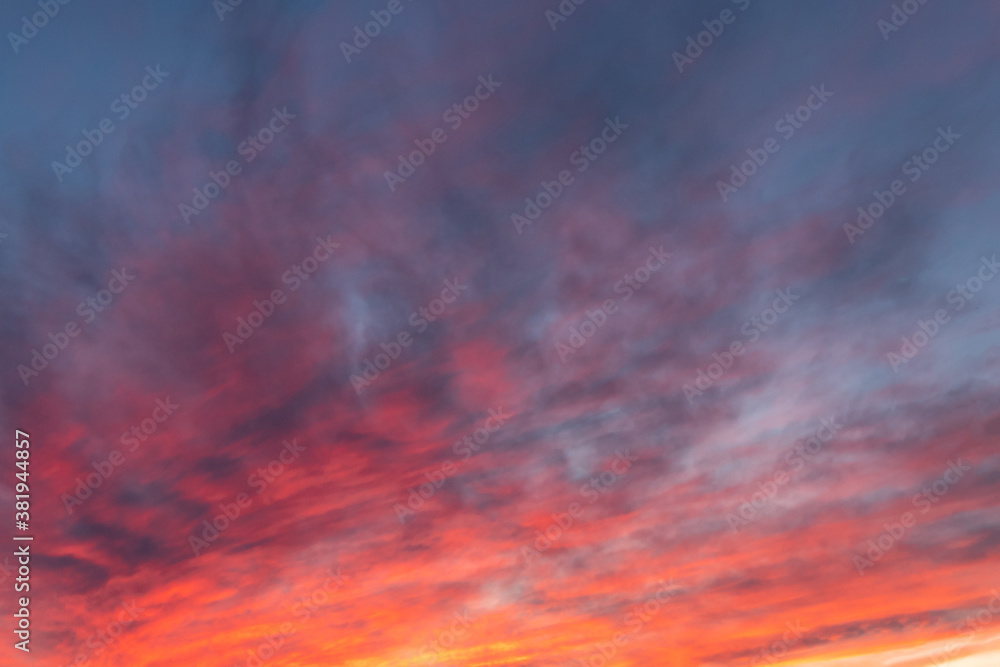 Red, orange, yellow, blue, sunset colors sky with clouds