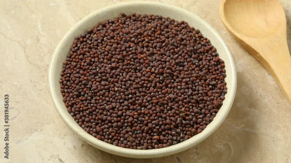 Bowl with black mustard seeds close up Bowl with black mustard seeds close up