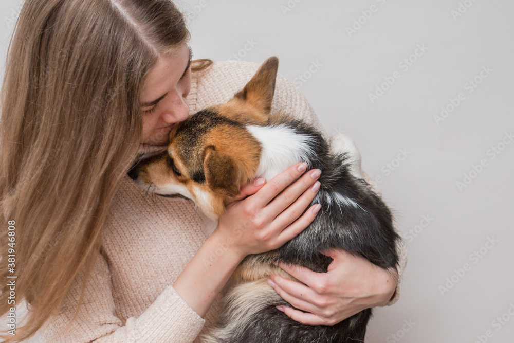 European woman in jacket with corgi pembroke dog European woman in jacket with corgi pembroke dog