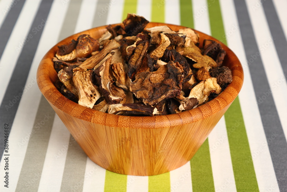 Dried mushrooms in wooden bowl. Boletus badius. Dried mushrooms in wooden bowl. Boletus badius.