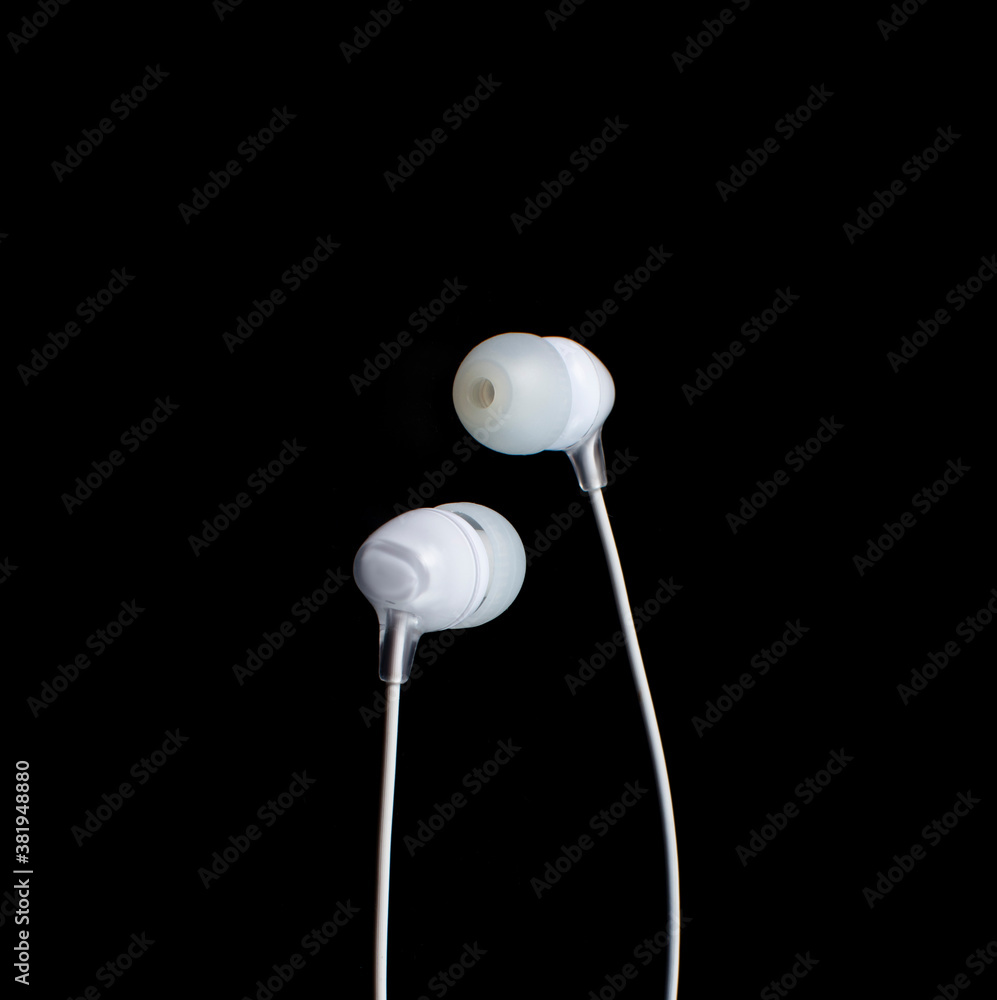 white headphones on a black background.copy space. white headphones on a black background.copy space.