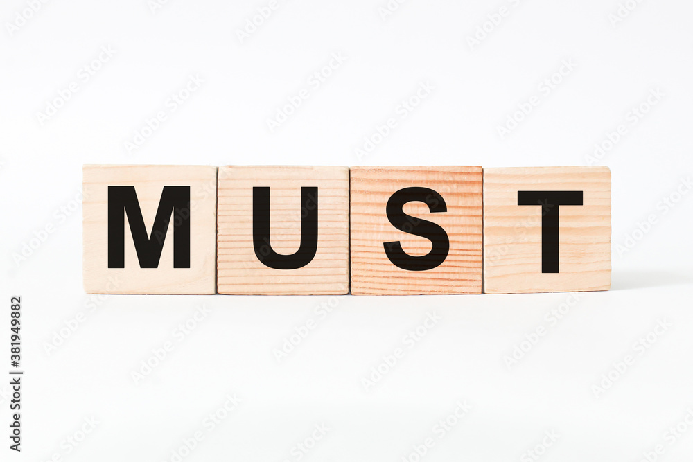 words MUST on wooden cubes, white background. business concept words MUST on wooden cubes, white background. business concept