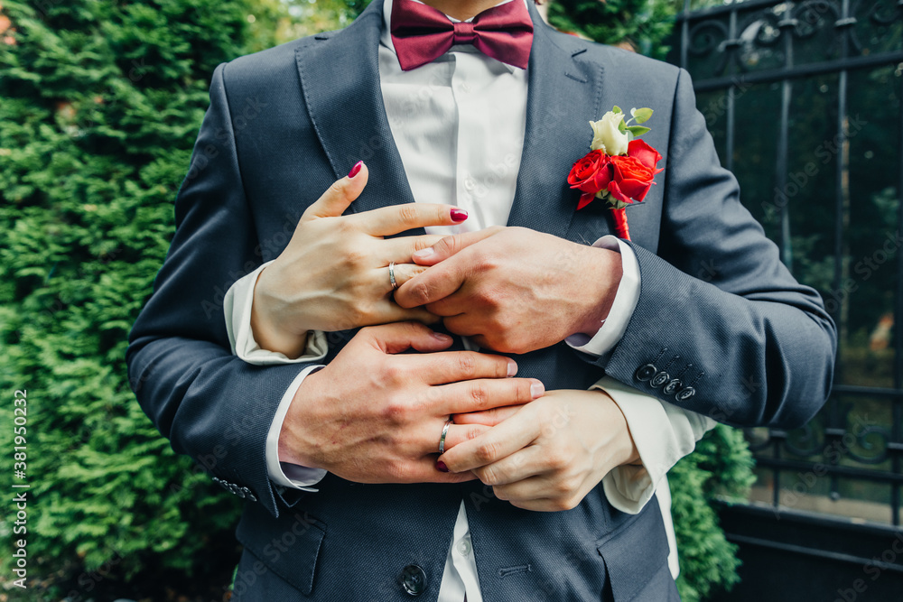 white gold wedding rings in a box and a bridal bouquet of delicate ...
