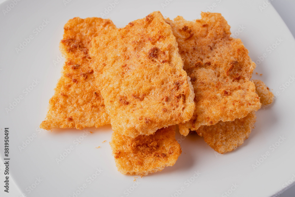 Rice cracker with flossy pork in a plate on a white background Rice cracker with flossy pork in a plate on a white background