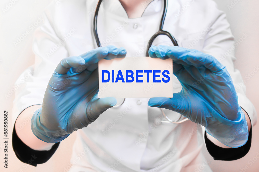 Doctor holding a card with text DIABETES, medical concept Doctor holding a card with text DIABETES, medical concept