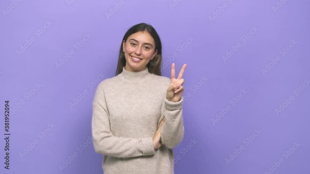 Young caucasian woman showing number two with fingers Young caucasian woman showing number two with fingers