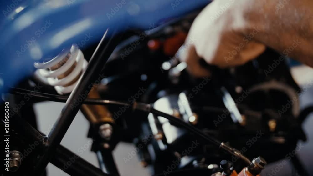 Man is working on motorcycle engine Man is working on motorcycle engine