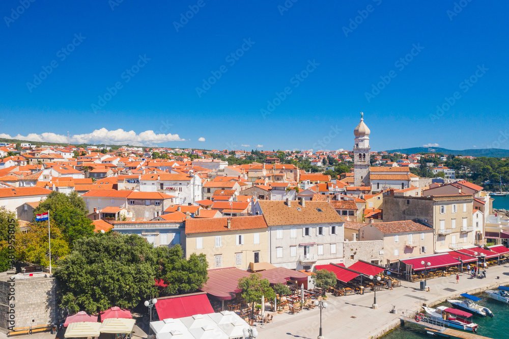 Old town of Krk in Croatia, cathedral tower and seascape in background