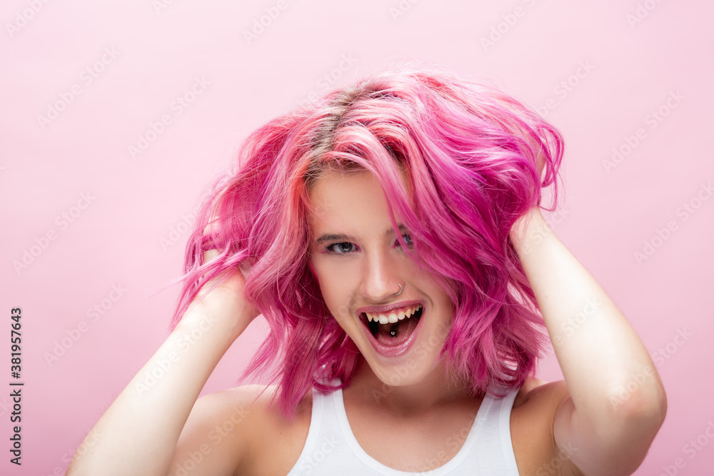 young woman touching colorful hair isolated on pink young woman touching colorful hair isolated on pink