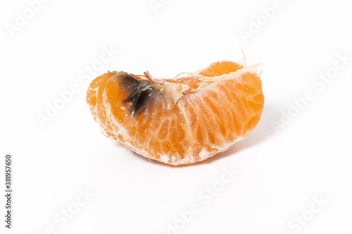 Bad moldy mandarin isolated on white background