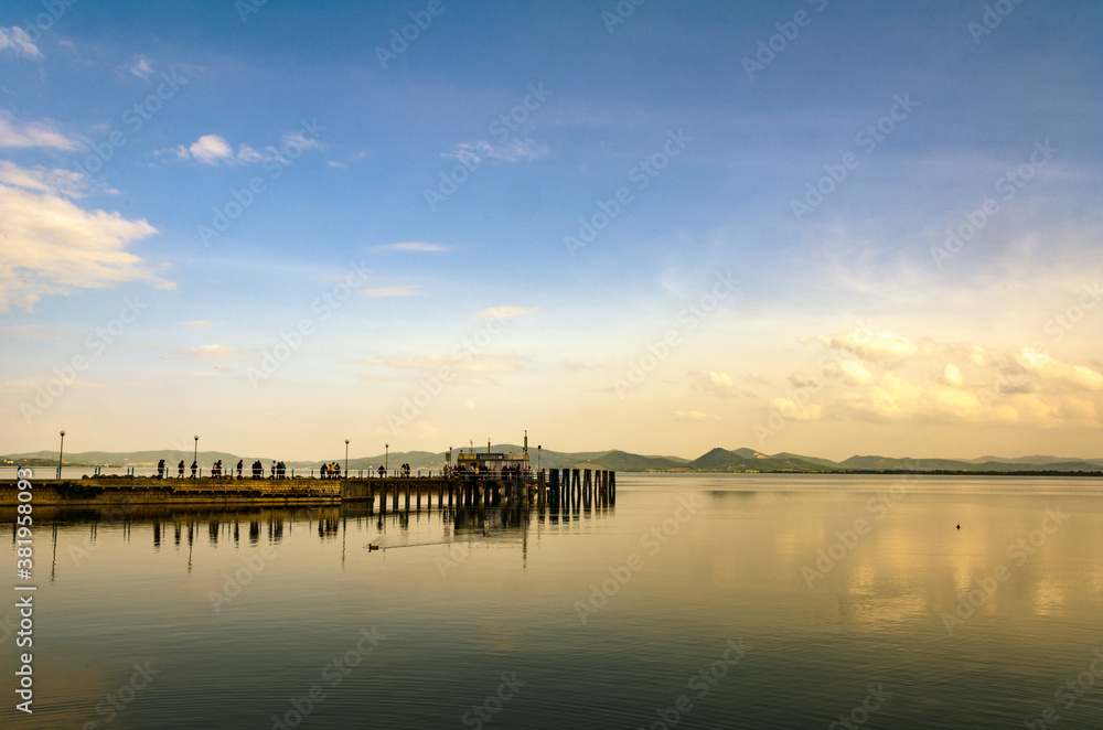 bridge in sunset on trasimeno lake