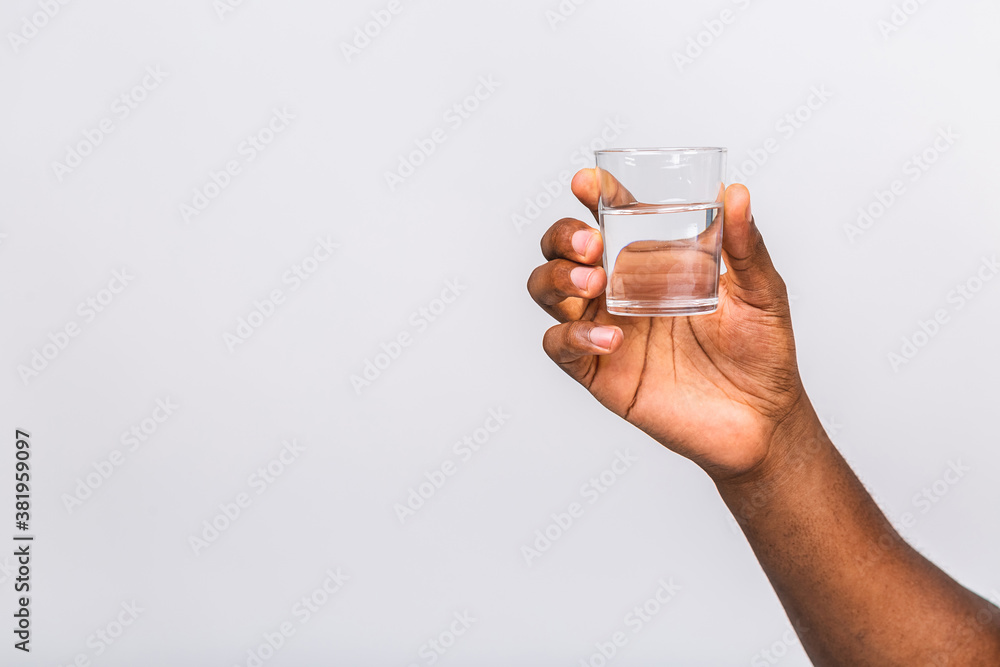 Black male african american hand holding glass of water isolated on white  background, closeup, cutout. Stock-foto | Adobe Stock