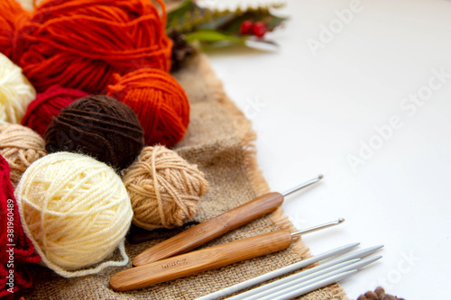 Cozy hobby concept. Crochet, knitting and knitting yarns, knitting needles and crochet hooks. photo