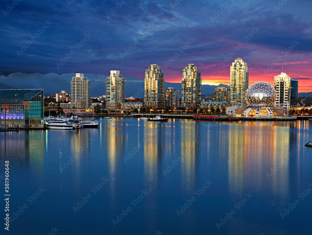 Skyline of Vancouver with Telusphere science centre and Burrard Inlet with sunset 