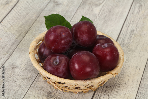 Plum heap in the wooden basket