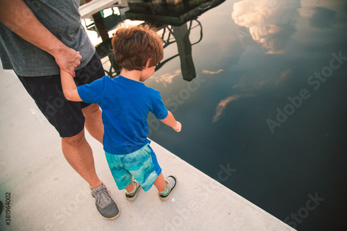 Fototapeta Marina with boats in Key Largo Florida dad and son looking for fish