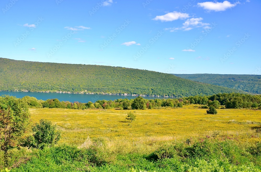 Landscape with lake and mountains, in the Finger Lakes region, New York. Early autumn scene 