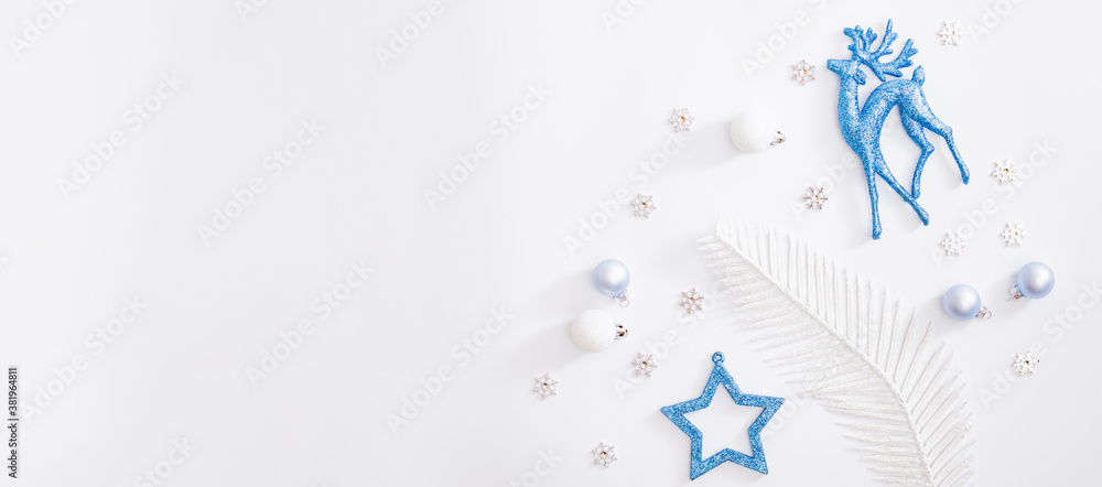 Flat lay frame with christmas baubles decoration and snowflakes on a white background