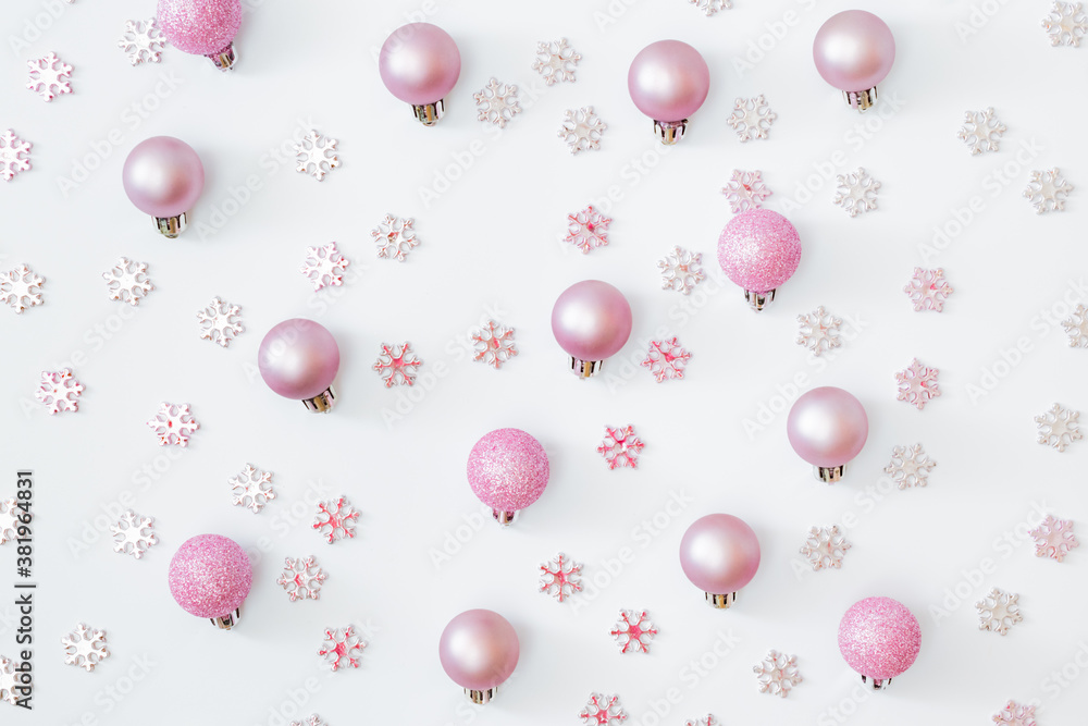 Flat lay pattern with snowflakes and christmas balls on a white background