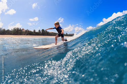 Photography Happy surf boy - young surfer learn to ride on surfboard with fun on sea waves