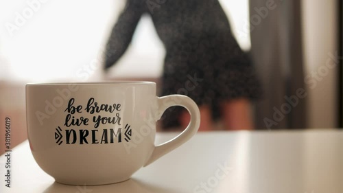 Achieving goals concept. Be Brave Live Your Dream and girl looks out the window