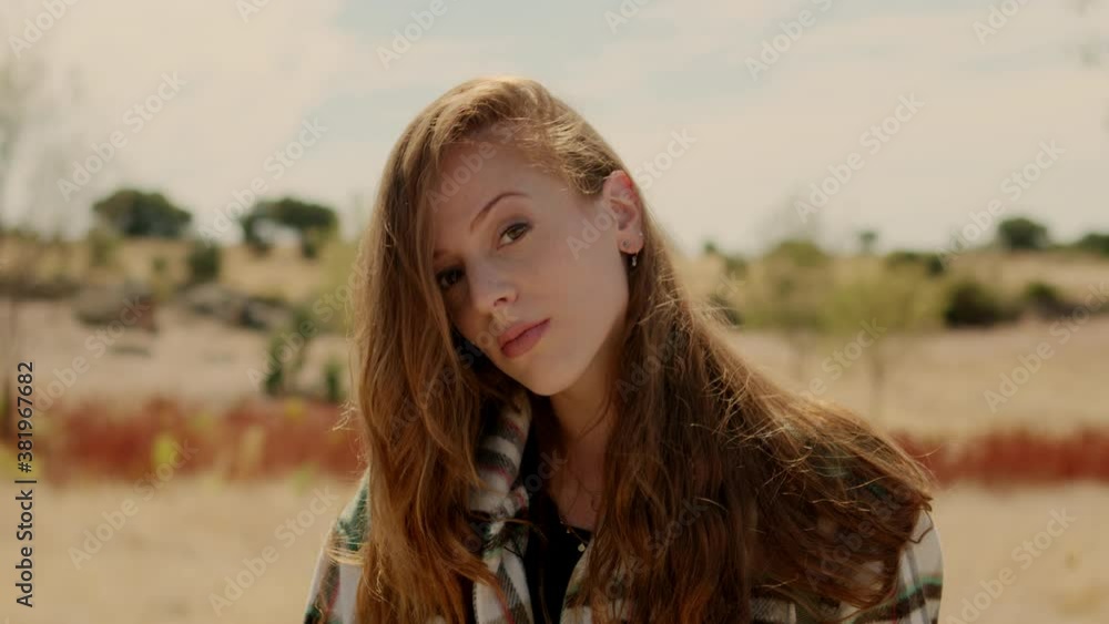 Close up of a beautiful girl looking at the camera with a shy smile Close up of a beautiful girl looking at the camera with a shy smile