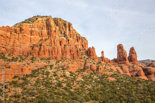 A formation of huge red sandstone rocks and juniper trees outside the city of Sedona, Arizona