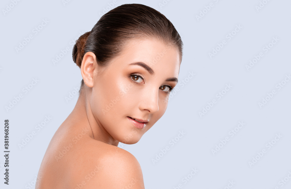Portrait of a beautiful smiling brunette woman with naked shoulders, with healthy clean skin and fresh make-up. Aesthetic cosmetology and makeup concept. Portrait of a beautiful smiling brunette woman with naked shoulders, with healthy clean skin and fresh make-up. Aesthetic cosmetology and makeup concept.