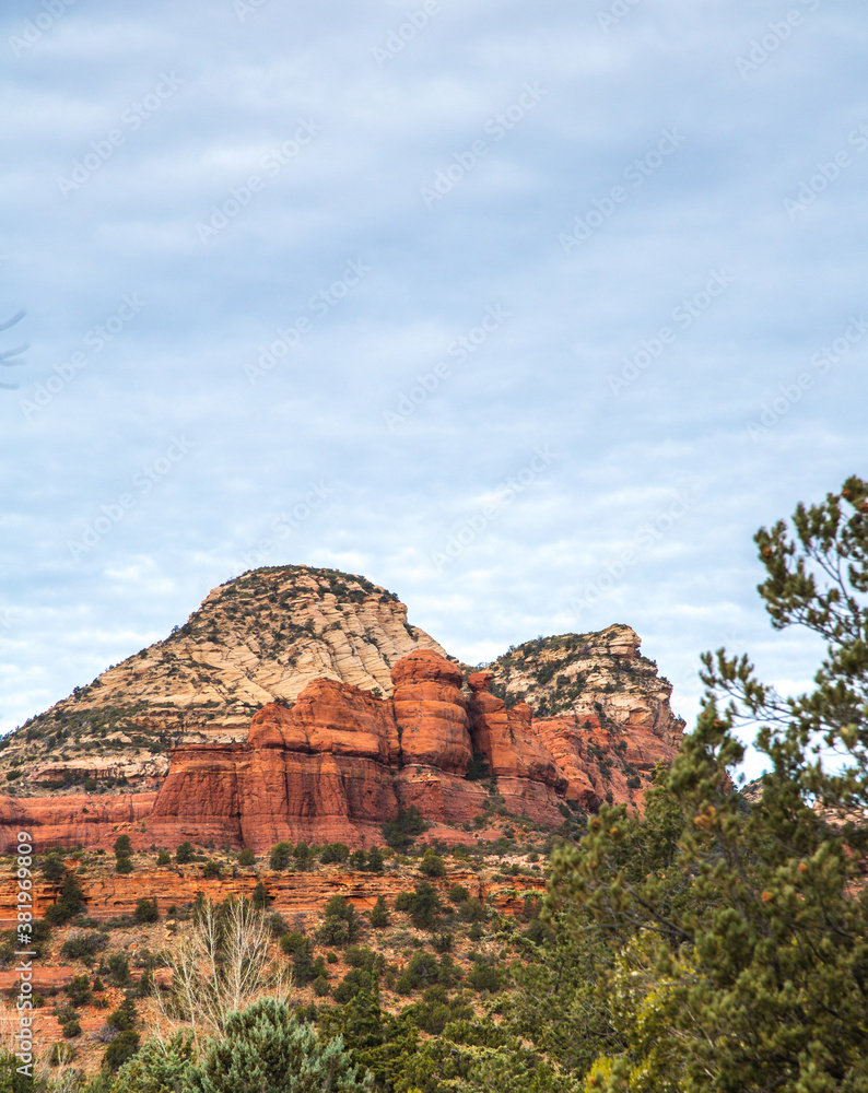 A formation of red sandstone rocks and juniper trees outside the city of Sedona, Arizona