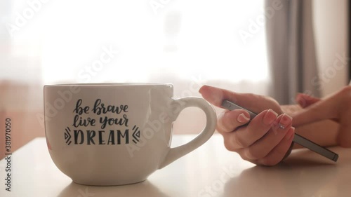 Achieving goals concept. Women's hands hold a smartphone and swipe