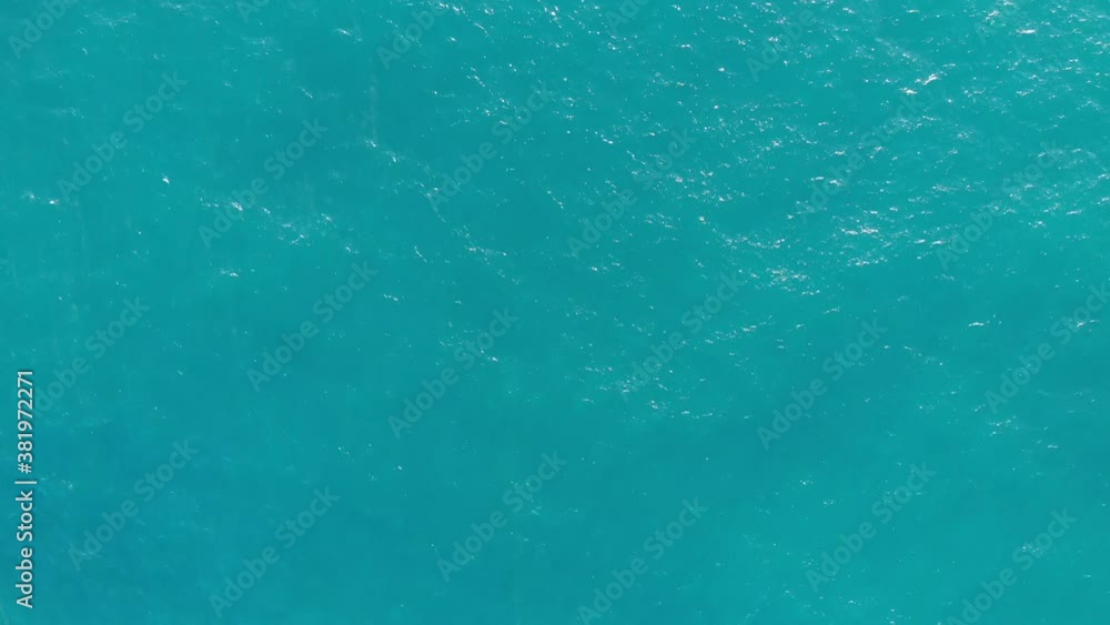 High flight over the calm turquoise sea surface on a sunny day. High flight over the calm turquoise sea surface on a sunny day.