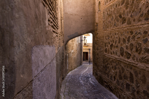 Looking down a medieval street in an ancient Spanish town on sunny day