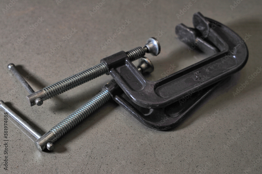 Black c-clamps with silver threads Black c-clamps with silver threads
