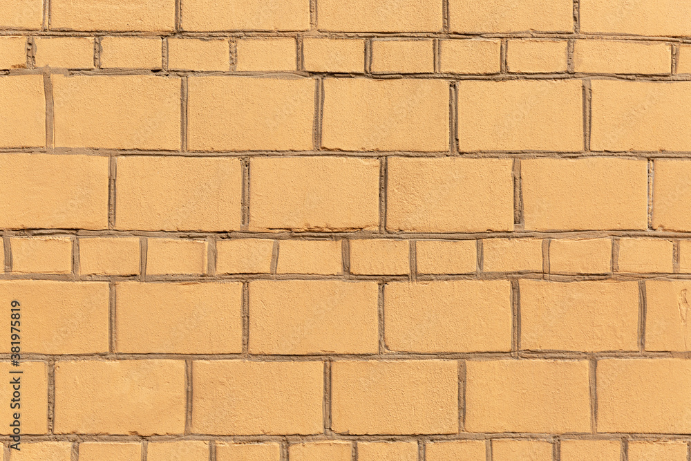 Fototapeta premium Surface of a yellow modern brick wall. Exterior of the building. Background. Space for text.