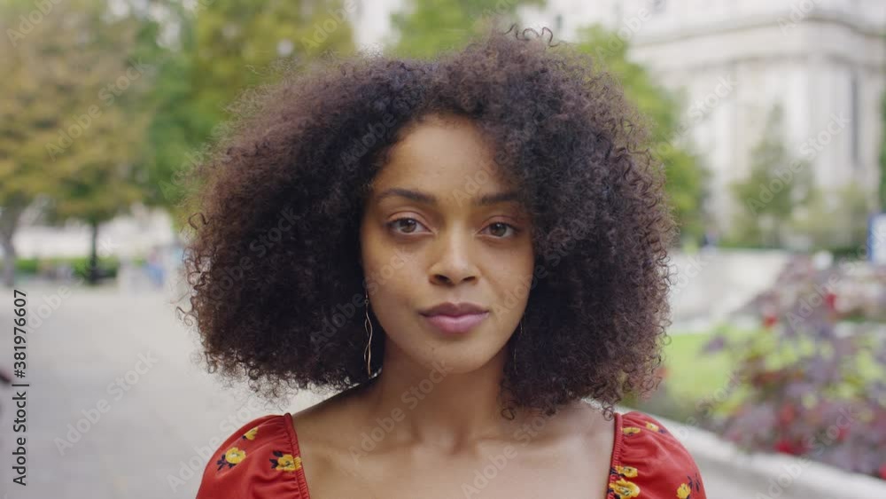 Portrait of young black female looking to camera with no expression Portrait of young black female looking to camera with no expression