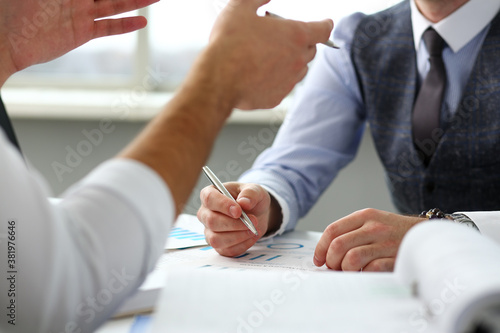 Two clerk businessmen with silver pen in arms deliberate on problem at office workplace closeup. Financial advisor specialist colleague coworking audit cooperation concept