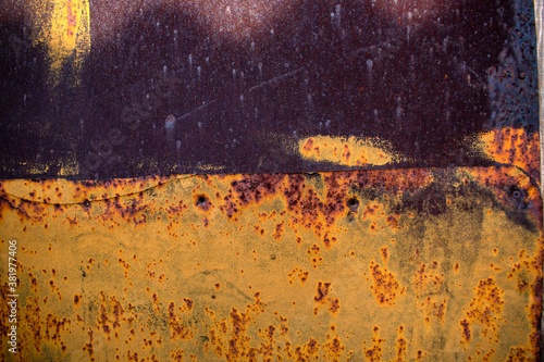 old , rusty tin sheet painted yellow and dark brown