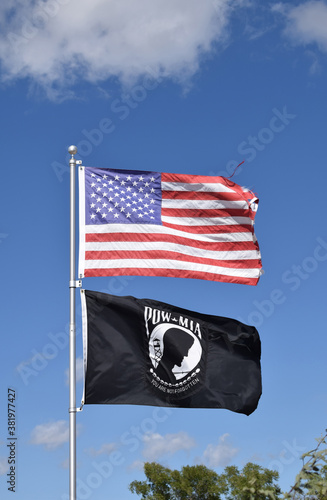 american flag and POW MIA flag in the wind