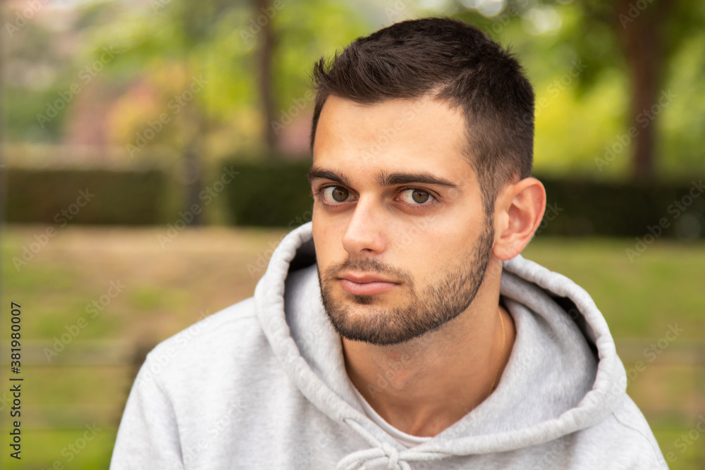 portrait of young man with beard outdoors portrait of young man with beard outdoors