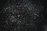 Christmas Silver glitter on black background. Holiday abstract texture