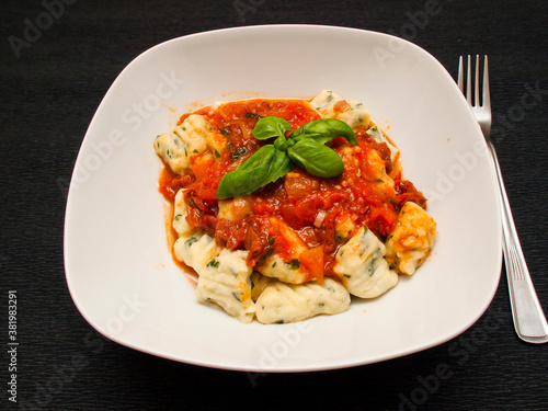 Herb gnocchi with tomato sauce and basil