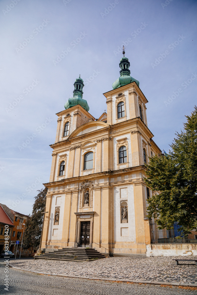 Church of the Annunciation in the main Republic square of Duchcov in sunny day, Northern Bohemia, Czech Republic