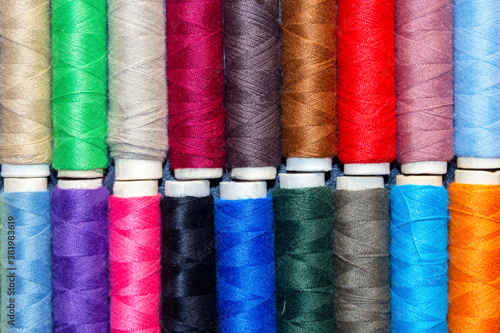 top view of spools with threads of different colors top view of spools with threads of different colors