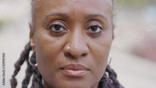 Close up portrait of mature black female looking to camera with no expression