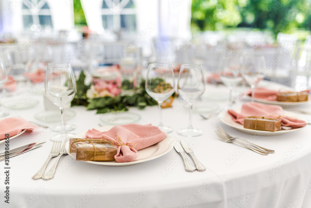 Fototapeta premium Luxury wedding table decoration in pink and white. Special event table set up. Fresh flower decoration.