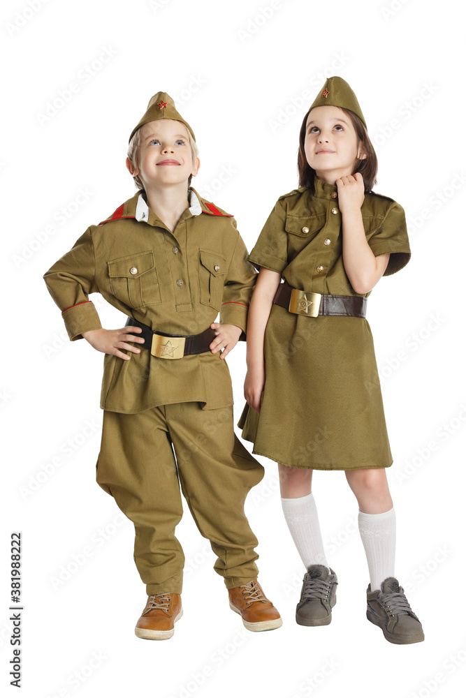 Thoughtful boy and girl wearing USSR military uniform.are holding hands isolated at white background. Concept of children friendship. Thoughtful boy and girl wearing USSR military uniform.are holding hands isolated at white background. Concept of children friendship.