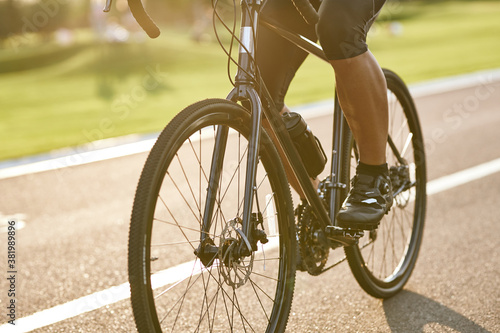 Close up shot of male cyclist legs, man cycling outdoors on a summer day